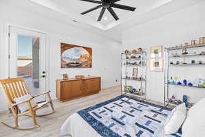 Bedroom with light wood-style floors, ceiling fan, and recessed lighting