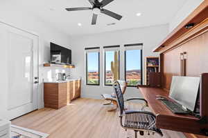 Office space featuring light wood-style floors, ceiling fan, and recessed lighting