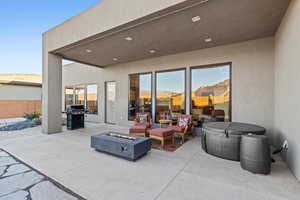 View of patio / terrace with an outdoor fire pit and grilling area