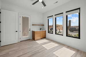 Unfurnished room with light wood-type flooring, ceiling fan, and recessed lighting