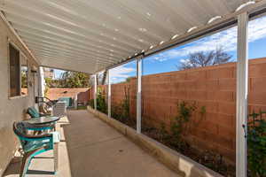 Fenced backyard with a patio