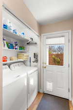 Laundry area featuring light wood-type flooring and separate washer and dryer