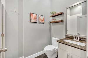 Bathroom with vanity and dark tile patterned flooring