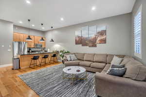 Living area featuring light wood-style flooring and recessed lighting