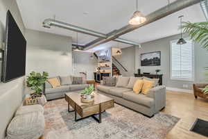 Living room with wood finished floors and beverage cooler