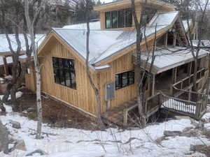 Snow covered property with a deck