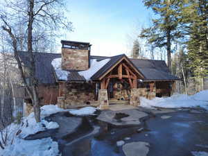 View of front of home with stone siding and a standing seam roof