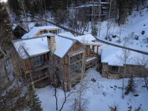 View of snowy exterior featuring a chimney