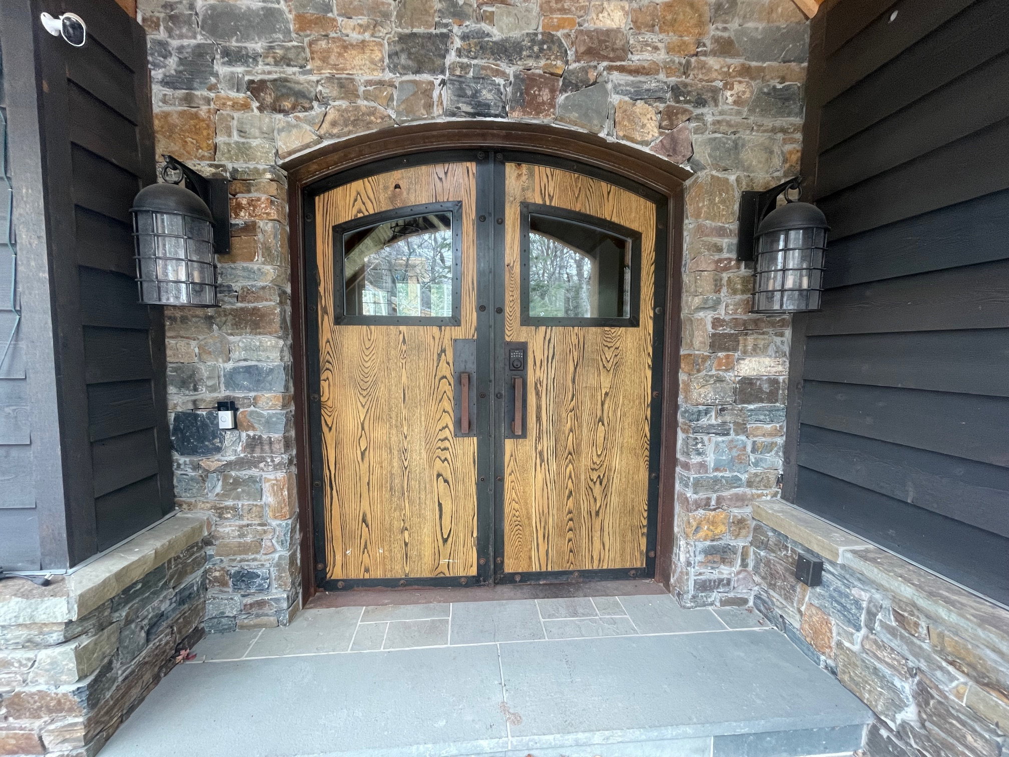 Entrance to property with stone siding
