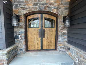 Entrance to property with stone siding