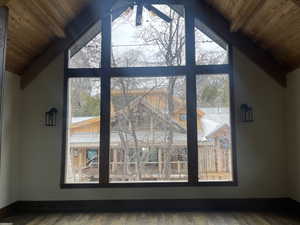 Detailed view of a wood ceiling with exposed beams and wood finished floors