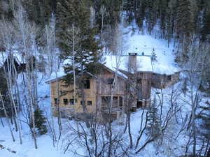 View of snowy exterior with a chimney