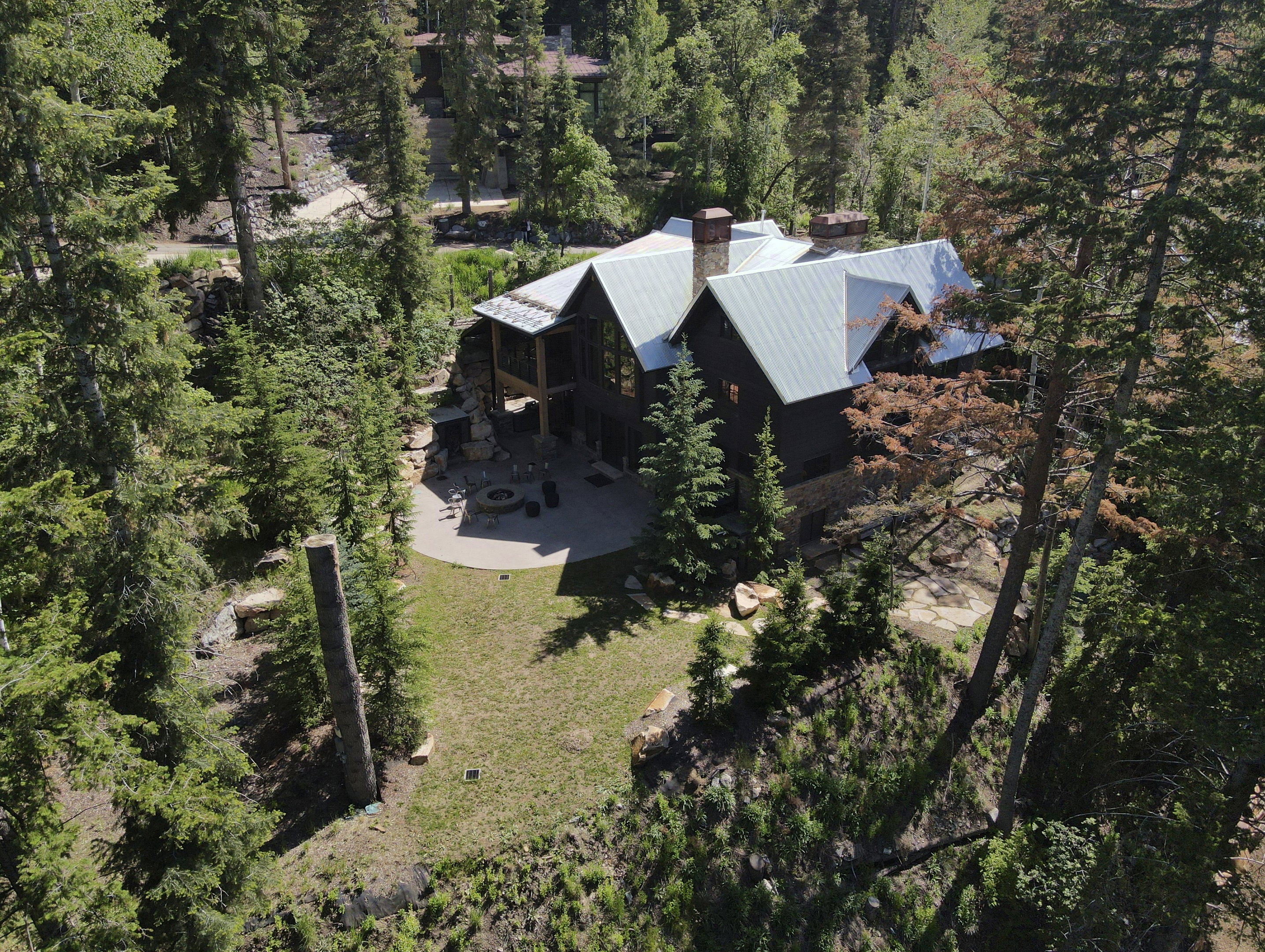 Mountain retreat featuring a large dwelling with multiple gables and a metal roof