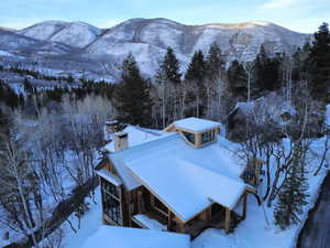 Snowy aerial view featuring a mountain view