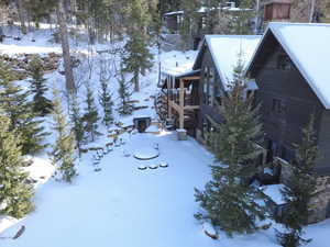 Snowy yard with a balcony