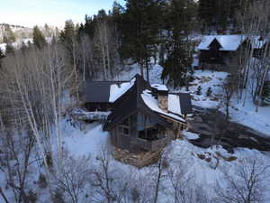 View of snowy exterior with a chimney