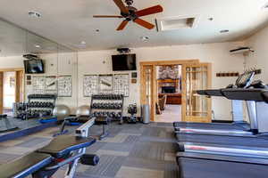 Workout area with ceiling fan and recessed lighting