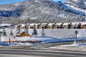 View of mountain backdrop featuring nearby suburban area