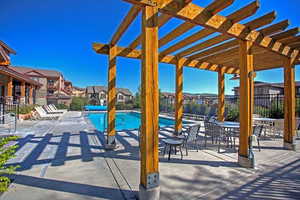 View of patio featuring a residential view, a community pool, and a pergola