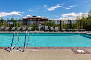 Community pool featuring a patio