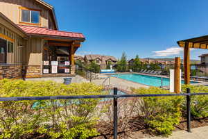 Community pool featuring a residential view and a patio area
