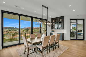 Dining room with light wood-type flooring, recessed lighting, and a mountain view