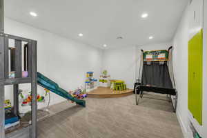 Game room featuring recessed lighting and light carpet