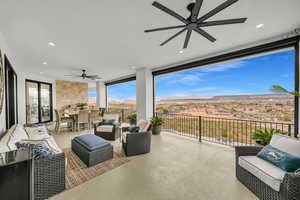 View of patio / terrace with ceiling fan, an outdoor living / dining area, and a mountain view