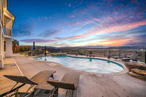 Combined pool / hot tub featuring a fenced backyard, a patio, a mountain view, and outdoor dining area