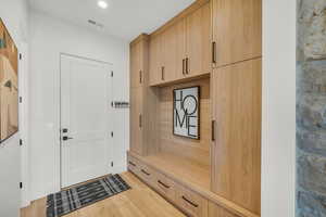 Mudroom with light wood-style flooring and recessed lighting