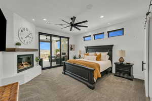 Bedroom with a brick fireplace, carpet floors, access to exterior, ceiling fan, and recessed lighting