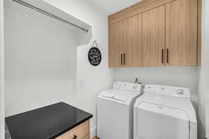 Laundry room with cabinet space and washing machine and dryer