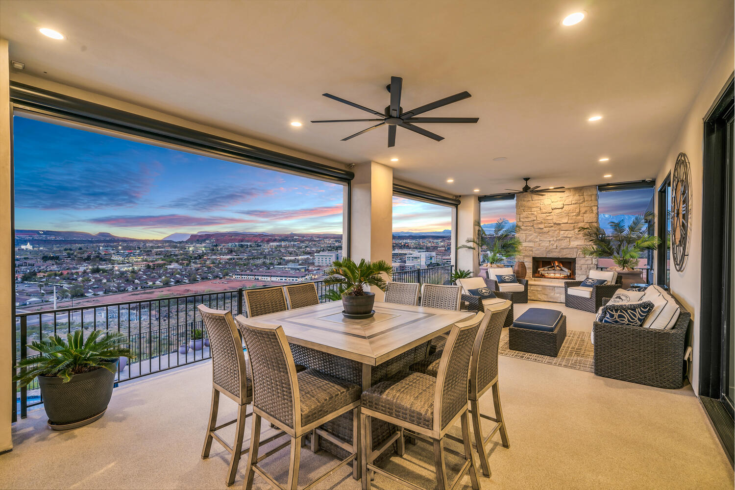Dining area featuring light colored carpet, ceiling fan, an outdoor stone fireplace, and recessed lighting