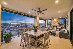 Dining area featuring light colored carpet, ceiling fan, an outdoor stone fireplace, and recessed lighting