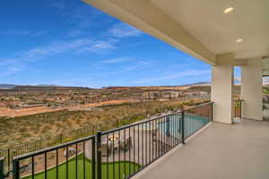 Balcony featuring a mountain view, view of pool area, and a residential view