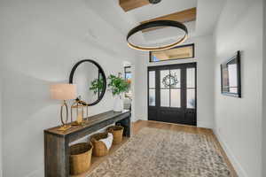 Entrance foyer with wood finished floors and baseboards
