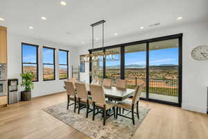 Dining room with a mountain view, light wood-style floors, and recessed lighting