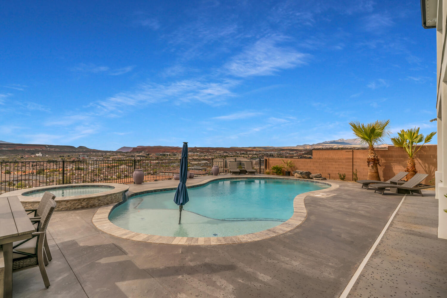 Relaxing pool / spa with a patio, a fenced backyard, and a mountain view