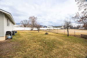 Fenced backyard featuring a residential view