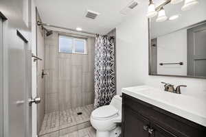 Full bath featuring a shower stall and vanity