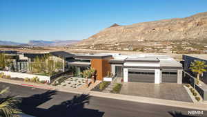 View of front facade with a mountain view, driveway, and an attached garage
