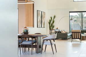 Dining room with a high ceiling and beautiful lighting.
