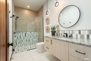Guest bathroom with vanity and a stall shower