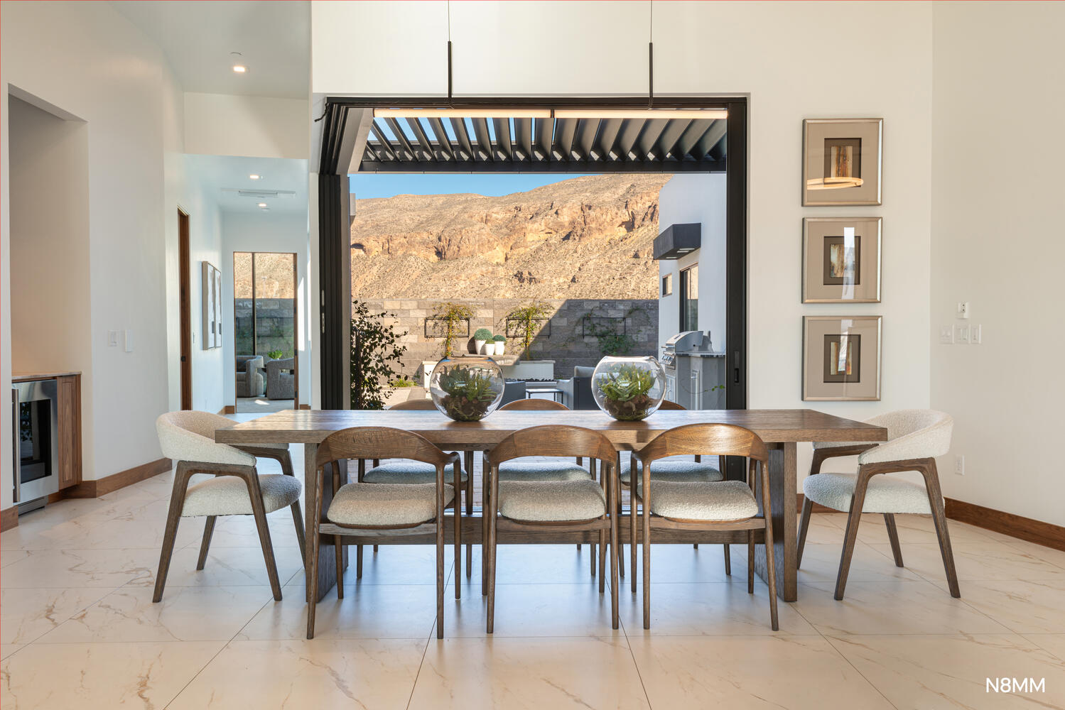Dining room with a mountain view and entrance out to the pool.
