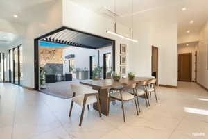 Dining area with recessed lighting and a high ceiling