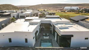 Aerial view of residential area featuring mountains and a golf club