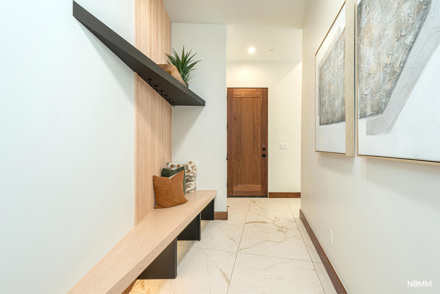 Mudroom area with light finish flooring and recessed lighting