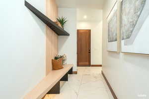 Mudroom area with light finish flooring and recessed lighting