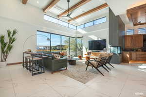 Living area with a ceiling fan, light finish flooring, recessed lighting, and healthy amount of natural light from the stunning windows.
