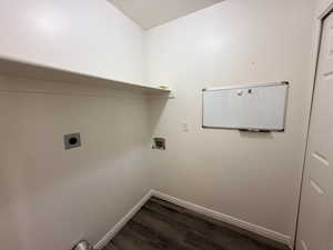 Laundry room with dark wood-type flooring, hookup for a washing machine, electric dryer hookup, and a textured ceiling